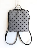 gray mickey mouse disney backpack, rounded style rucksack with zipper pocket, bohemian disney land backpack, backpack with small mickey mouse heads, convertible shoulder bag