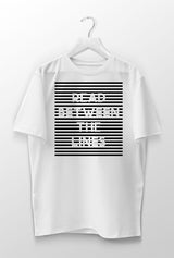 white unisex cozy tshirt with read between the lines design, unique streetwear graphic, inspirationa saying tshirt